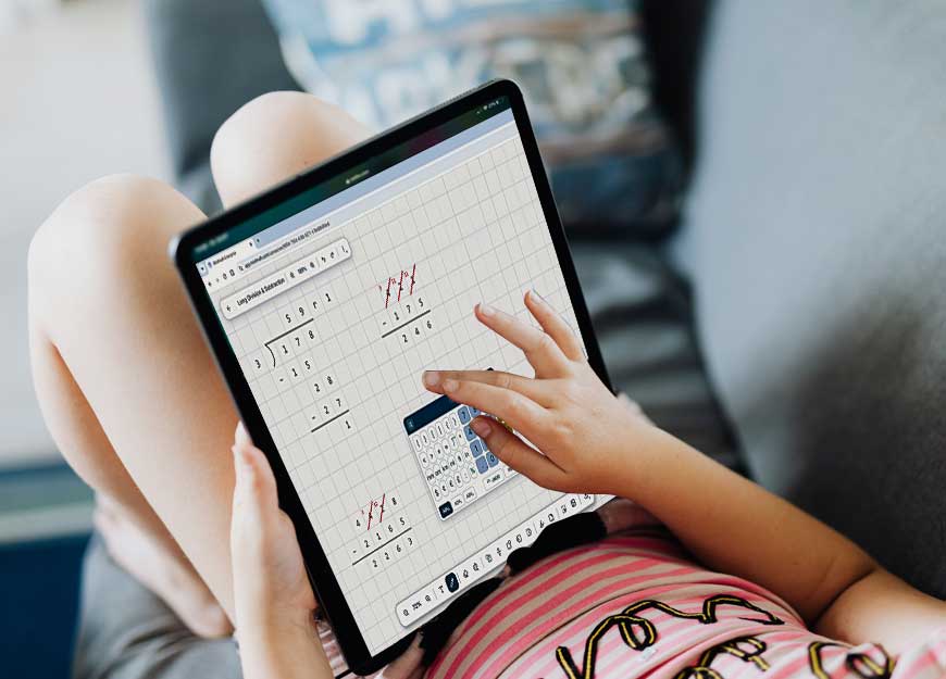 A child on a couch working on a long division problem in Modmath on a tablet.